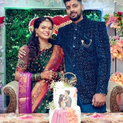The happy couple posing with their beautifully designed engagement cake, which features a custom illustration of them.
