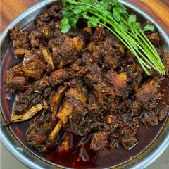 A rich and dark 'Nganu' (duck) curry, cooked Manipuri style. The duck is slow-cooked with spices until the meat is tender and flavorful.