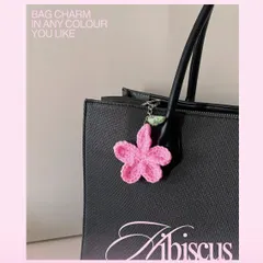 Here’s how the pink hibiscus charm looks on a classic black tote bag. I can make these in any color to match your personal style or your favorite bag.