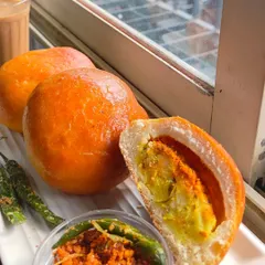 A look inside my Baked Vada Pav. The soft bun is stuffed with a spiced potato filling and dry garlic chutney, then baked to golden perfection.