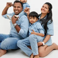 The playful energy in this family photo is infectious. I love capturing the fun dynamics, like a toddler perched on dad's shoulders. These are the happy, chaotic moments that define family life.