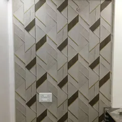 A 3D geometric wallpaper with interlocking shapes in neutral tones. This adds modern texture to a small space.