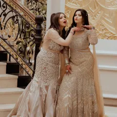 A playful moment between the bride Ekta and her sister Lekha on the grand staircase during the Roka festivities.