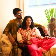 When Milan meets Paris in Mumbai. This shot captures a fusion of styles, with a modern brocade jacket for him and a floral mulmul shirt with bright pants for her. It's all about creating a vibe.