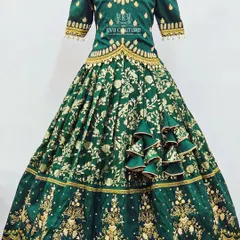 For a truly grand occasion, this emerald green velvet lehenga is a showstopper. The entire set is covered in heavy gold maggam work, from the detailed blouse to the borders of the full-flared skirt, creating a regal look for your little one.
