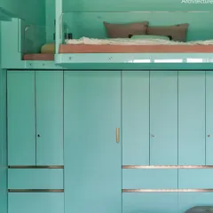 The loft bed in Project 704 is integrated with a full wall of wardrobe storage below. One of the wardrobe doors is a secret entrance to the bathroom, keeping the room's design clean and adding an element of fun.