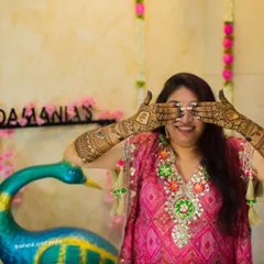 A fun and happy shot of a bride-to-be, her hands covered in beautiful henna. These are the moments that make the mehendi ceremony so special.