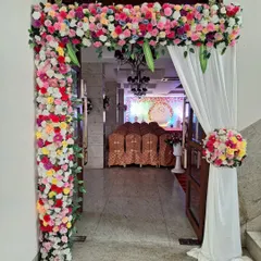 An elegant floral archway designed for the entrance of an engagement party venue. This welcoming decor sets the tone for the event and provides a beautiful photo opportunity for guests as they arrive.