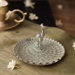 Here is my silver peacock centerpiece in a different setting, showing its versatility. The detailed engraving on each feather catches the light beautifully, making it a captivating object from every angle.