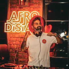 In my element at an Afrodisiac night, my signature event series dedicated to the best Afro house and Latin beats. The neon sign says it all. This is where I get to share the music I'm most passionate about, creating a unique, rhythm-filled atmosphere.