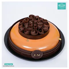 Our Chocolate Orange mirror glaze cake is a work of art. The glossy, vibrant glaze covers a rich mousse, and the cake is finished with intricate chocolate rose swirls.