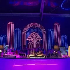 We believe the bar should be a masterpiece. Here’s a look at one of our stunning Art Deco-inspired neon bar setups, designed to be the glowing heart of your celebration.