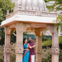This couple looks regal in their traditional outfits, posing inside a beautifully detailed gazebo. We ensure every element, from costume to location, is perfect.