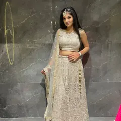 A simple and elegant off-white chikankari lehenga. This is a timeless rental piece that is perfect for a sophisticated day event or a puja ceremony.