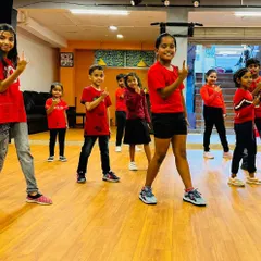 My little stars lighting up the dance floor. Here's a group of kids in matching red shirts, striking a pose during a shoot at the studio.
