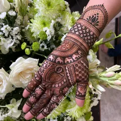 A simple yet elegant design for a family member or a smaller function. It features a prominent lotus motif on the wrist, surrounded by elephant and checkerboard patterns.