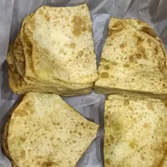 Stacks of soft, layered Rumali Roti, ready to be packed. They are the perfect bread to scoop up my rich and flavourful curries.