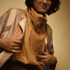 A candid, joyful moment from a studio session. This image captures the playful side of fashion, showing how comfortable and easy-to-wear these handmade pieces are.