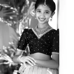 A beautiful black and white portrait of one of the sisters, highlighting the delicate embroidery on her custom blouse.