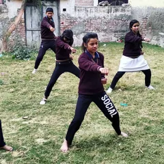 A group of young girls practicing their basic stances and punches during an outdoor session. Learning together builds teamwork and camaraderie among our students.