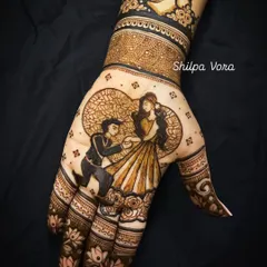 A beautiful engagement story captured in henna. This design features a romantic proposal scene on the palm, surrounded by delicate floral patterns.