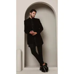 The 'Celestial' Shrug Set is the epitome of contemporary sophistication. It features a black asymmetrical kurta paired with a meticulously embroidered shrug, designed for the man who appreciates artistic expression.