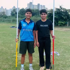 We build powerful throwers. Two of our dedicated javelin athletes posing with their equipment during a training session. We focus on developing both raw power and precise throwing technique.