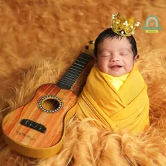 A little prince with a happy grin, ready to rock the world. We love capturing these spontaneous expressions of joy during our newborn sessions.