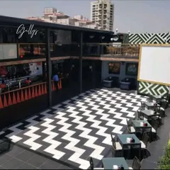 For this commercial project, we designed a multi-level hospitality space with a bold, graphic identity. The black and white chevron flooring creates a high-energy focal point for the entire venue.