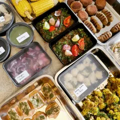 A behind-the-scenes look at a large catering order ready for delivery. This spread includes our ready-to-grill Tandoori Gobi, assorted kebabs, Smoked Chana, and Amritsari Kulchas with all the fixings.