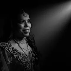 A single beam of light can tell a powerful story. For this black and white bridal portrait, we used a spotlight effect to draw the eye directly to the bride's hopeful gaze, creating a dramatic and emotive image that feels both classic and modern.
