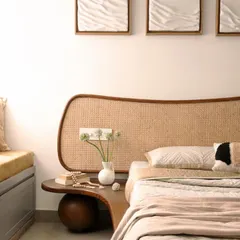 For this bedroom in a compact city apartment, I designed a custom bed with an organically shaped, woven cane headboard that extends into a floating bedside table. This piece combines form and function, creating a soft, natural focal point while saving space.