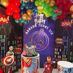 A close-up of our Avengers theme birthday decoration. This view highlights the custom-printed backdrop with the Avengers logo, themed pedestals for the cake, and superhero character standees.