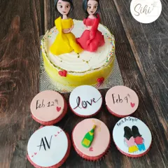 I made this set for two best friends celebrating their bachelorette parties together. The cake features 3D fondant figures of them, with cupcakes marking their special dates.