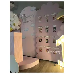 A 'My First Year' photo board designed for a rainbow-themed birthday. This cloud-shaped display showcases photos from each month of the baby's first year, creating a heartwarming focal point.