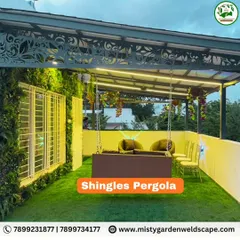 A modern shingles pergola provides a waterproof and stylish covering for this terrace. The addition of a decorative fascia, vertical garden, and swing creates a complete and luxurious outdoor space.