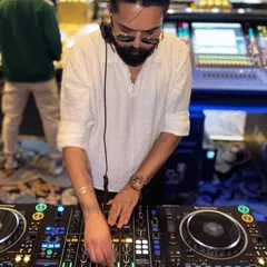 My hands on the mixer, crafting the perfect sound for the dance floor. Every track is chosen to build momentum and keep the party going.
