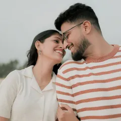 A close-up shot capturing a genuine smile and connection. These are the candid couple portraits that truly tell your story, focusing on the small, happy moments.