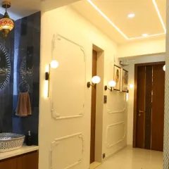 This passageway in our Persian-themed project is lined with elegant wall mouldings and classic light fixtures, creating a sophisticated and timeless look.
