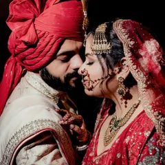 A close-up portrait capturing the quiet intensity and emotion between a bride and groom. The focus on their expressions and the rich details of their wedding attire makes this a powerful and timeless image.