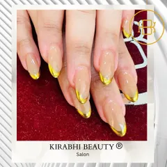 Elegance with an edge. These almond-shaped extensions feature a clear base with stunning gold chrome French tips for a luxurious and modern manicure.
