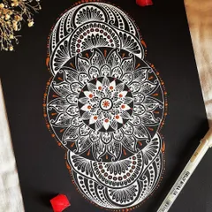 A different take on the classic mandala, this piece uses a unique three-part structure. The white and bronze gelly roll pens create a sophisticated and modern look on the black paper, perfect for a contemporary space.