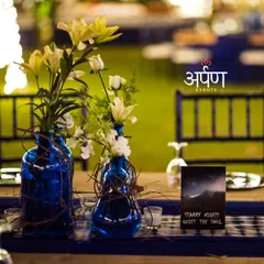 Attention to detail is key. For this "Starry Nights" themed party, even the table centerpieces, featuring blue vases and custom cards, were designed to enhance the magical ambiance of the evening.