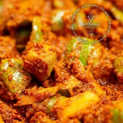 A close-up look at the rich texture of our artisanal Khatti Keri Mustard pickle. You can see the chunks of mango perfectly coated in our freshly ground spice blend.
