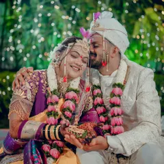 This intimate wedding moment captures the pure joy and connection between a couple. The groom's gentle kiss on the bride's forehead is a timeless expression of love that we specialize in preserving.