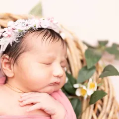 Pure love in its smallest form. This macro shot focuses on the serene face of a sleeping newborn, highlighting her soft skin and tiny features.