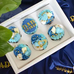 A box of six cupcakes designed especially for Father's Day. The blue and white theme with gold accents and "DAD" toppers makes for a very handsome and tasty gift.