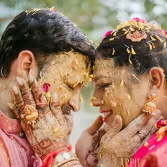 A beautiful, intimate moment amidst the fun of the haldi ceremony. Arpit and Vasundhara, covered in haldi, share a look of pure love and happiness.
