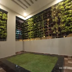 Even compact spaces can become a green sanctuary. We designed and installed this extensive vertical garden, or living wall, complemented by a patch of soft lawn and ambient lighting for a stunning evening view.