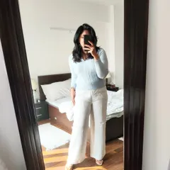 A simple yet elegant combination of white linen pants and a powder blue pullover, accessorized with pearls for a lunch catch-up.